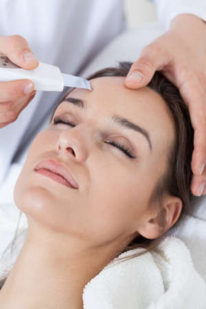 Relaxed woman during cavitation peeling in spa