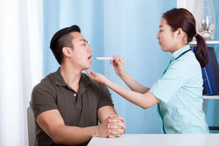 View of asian man during throat examinationの写真素材