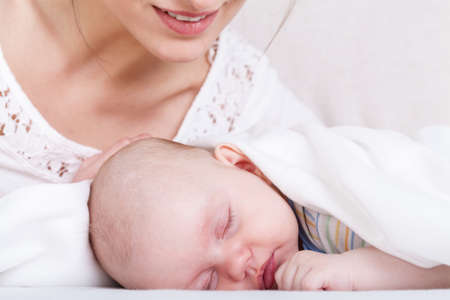 Close-up of little baby with mother, horizontal