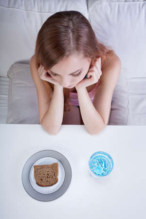 Young skinny girl on a bread and water dietの写真素材