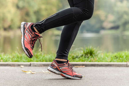 Close-up of young running in park woman's feetの写真素材