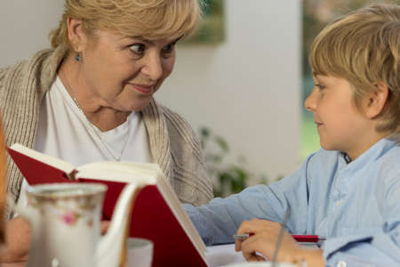 Portrait of senior babysitter caring about schoolboy