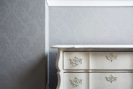 Close-up of retro style white sideboard in the cornerの写真素材