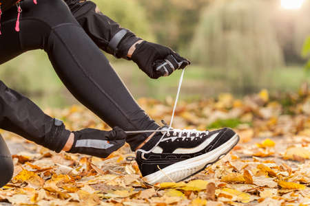 Close-up of tying shoelaces in new jogging shoesの写真素材