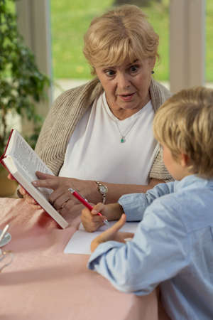 Vertical view of grandma teaching his grandson