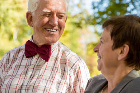 Close-up of smiling elderly man looking at his happy womanの写真素材