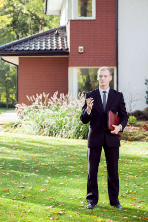 Vertical view of elegant house agent wearing suitの写真素材