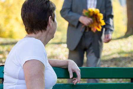 Close-up of aged woman in park sitting on a benchの写真素材