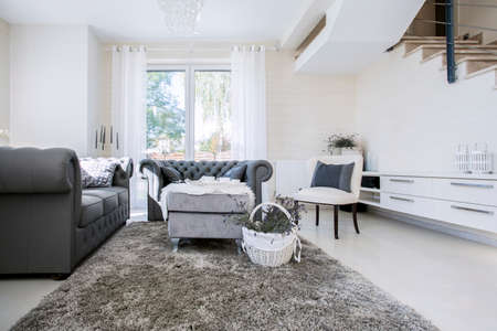 Big white living room with grey sofas