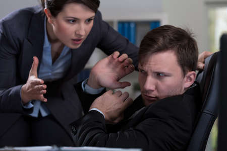 Young handsome man and workplace bullyingの写真素材