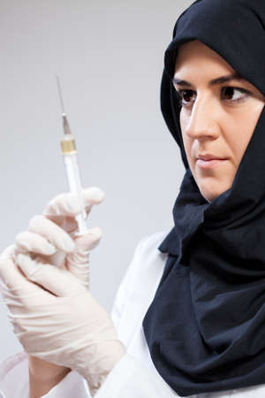 Muslim nurse going to give an injectionの写真素材