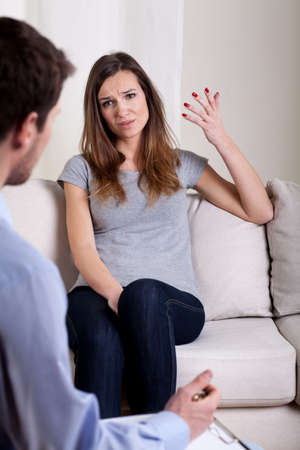 Lady talking about problems with psychotherapist, verticalの写真素材