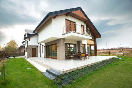 Horizontal view of single-family home with patio