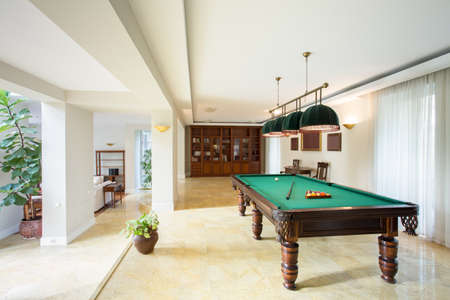 Billiard table in living room in luxury apartment