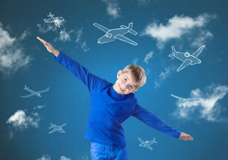 Little happy boy trying to fly like an airplaneの写真素材