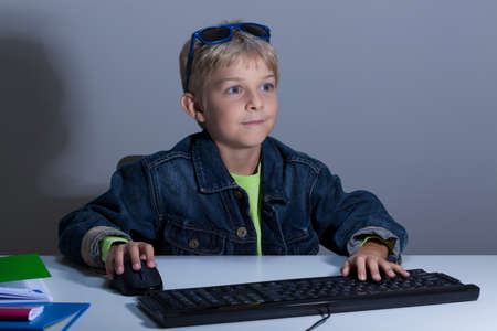 Child playing on computer at night, horizontalの写真素材