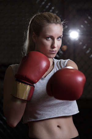 View of athletic girl wearing boxing glovesの写真素材