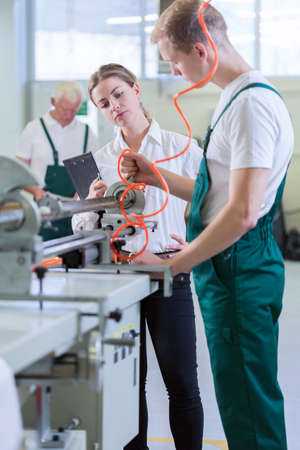 Female engineer controlling machines in production centre