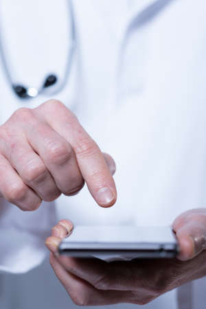 View of male doctor using mobile phoneの写真素材