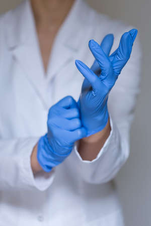 View of female doctor wearing protective glovesの写真素材