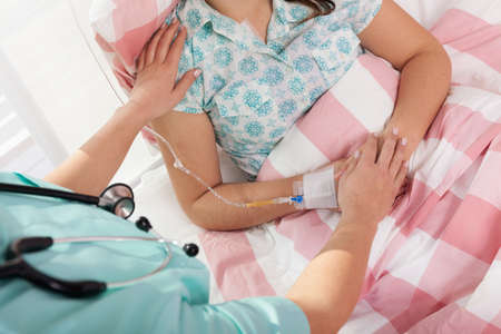Doctor caring about patient lying in hospital