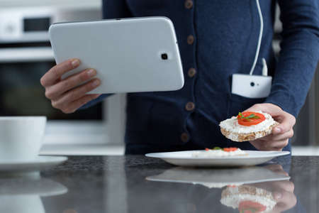 Close-up of white tablet in woman's handsの写真素材