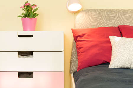 Small night lamp hanged above the bedの写真素材