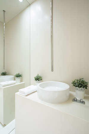 View of designed faucet inside white bathroomの写真素材