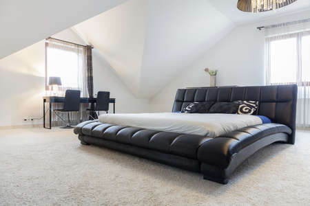 View of designed bed in modern bedroomの写真素材