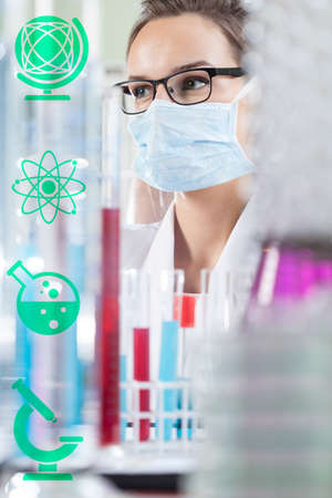Female chemist in laboratory and chemistry iconsの写真素材
