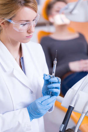 Portrait of stomatologist holding syringe with anestheticの写真素材