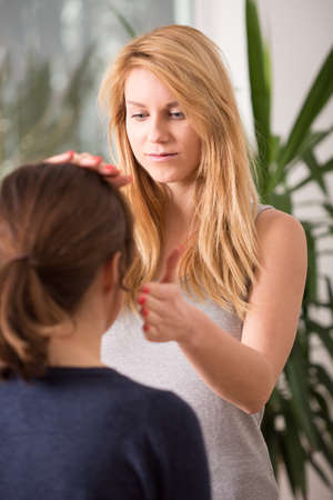 Young pretty female bioenegrotherapist in health resortの写真素材