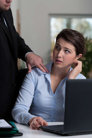 Cruel boss controlling his afraid young employeeの写真素材