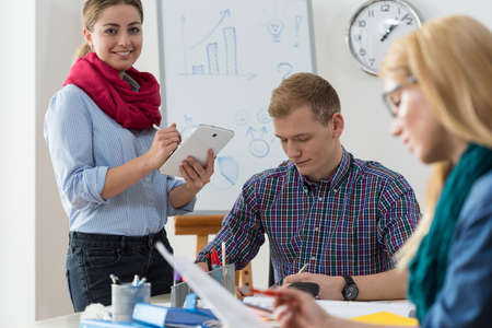 Young people working in office in pleasant atmosphere