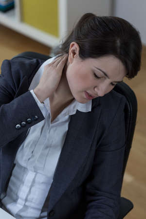 Woman with neck pain after long time at workの写真素材