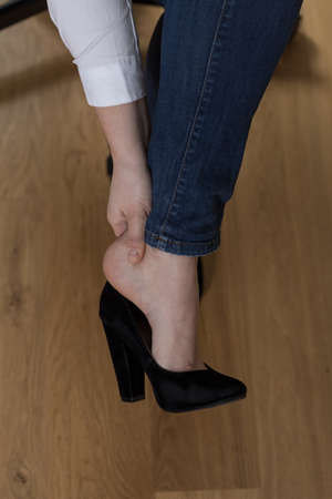 Close-up of young woman's aching feet in high heelsの写真素材