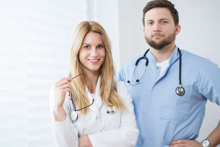 Portrait of young smiling physicians working at hospitalの写真素材