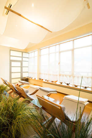 Small living room with flowers and sunbeds in spa resortの写真素材