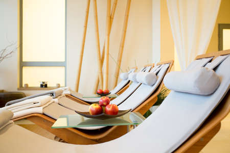 Close-up of wooden fancy loungers in restful room