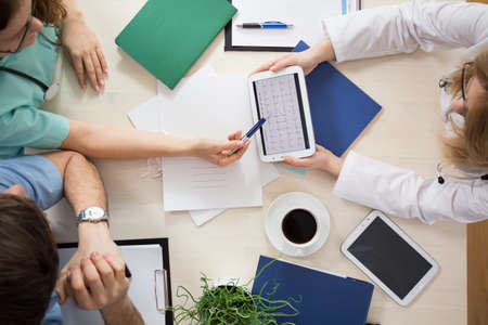 Cardiologists using digital tablet during medical meetingの写真素材