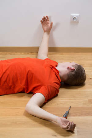 Image of electrocuted man lying on the floorの写真素材