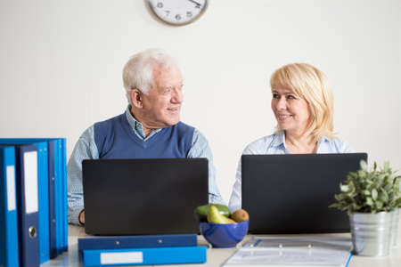 Elderly busy couple running together a business