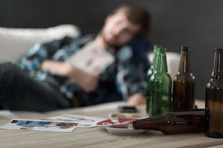 Close-up of empty beer bottles on the tableの写真素材