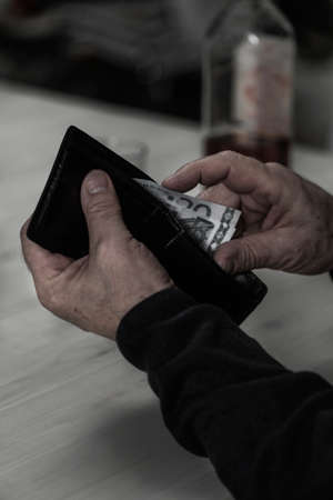 Retired alcoholic spend his pension for drinkの写真素材