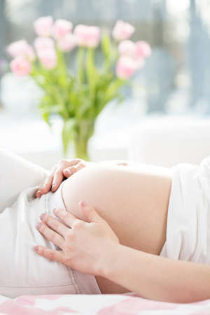 Close-up of young gravid woman's stomach