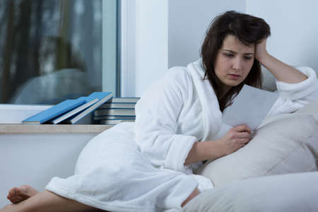 Young depressed woman recollecting the pastの写真素材