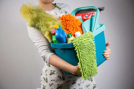 Close-up of woman holding bucket full of cleanersの写真素材