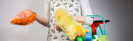 Panoramic photo of woman with orange glove dusterの写真素材