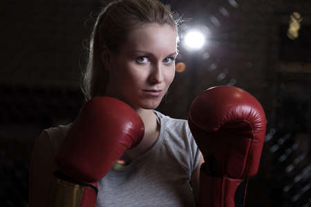 Beauty fighting girl wearing boxing gloves