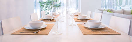 Elegant laid table in dining room - panoramaの写真素材